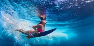 The absolute best spots in Tasmania to surf up a storm A lady underwater in Tasmania surf